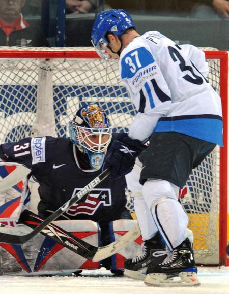 Mika Pyorala shoots on USA goalie Robert Esche in the 2009 IIHF World Championships.